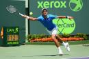Novak Djokovic of Serbia stretches to play a forehand against Andy Murray of Great Britain in the men's final during the Miami Open on April 5, 2015 in Key Biscayne, Florida