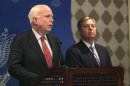 U.S. Senator John McCain speaks as compatriot Senator Lindsey Graham looks on during a news conference in Cairo