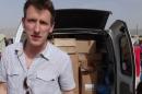 US aid worker Peter Kassig in front of a truck somewhere along the Syrian border between late 2012 and autumn 2013