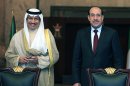 Iraqi Prime Minister Nouri al-Maliki, right, and his Kuwait counterpart Sheikh Jaber Al Mubarak Al Hamad Al Sabah, left, attend a signing ceremony in Baghdad, Iraq, Wednesday, June 12, 2013. Kuwait's prime minister has arrived in Baghdad on an official visit, signaling the improving ties between the two neighbors. Officials later signed a series of agreements aimed at improving bilateral ties in the economic, transportation and other sectors. (AP Photo/ Karim Kadim, Pool)