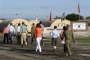 Members of the media pool move to the courtroom at the U.S. Navy base at Guantanamo Bay