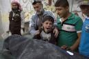 A Syrian boy reacts to the loss of a relative who died in an airstrike in a rebel-held neighbourhood of Aleppo