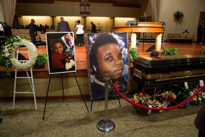 Photos surround Michael Brown's casket before the start of his funeral at Friendly Temple Missionary Baptist Church on Aug. 25. (AFP/Richard Perry)