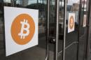 Bitcoin themed stickers stand attached to glass doors during the Inside Bitcoins: The Future of Virtual Currency Conference in New York