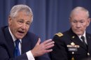In this April 10, 2013, photo, Defense Secretary Chuck Hagel, left, accompanied by Joint Chiefs Chairman Gen. Martin Dempsey, speaks at a news conference at the Pentagon in Washington, about the fiscal year 2014 defense budget. (AP Photo/Carolyn Kaster)