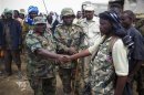 Handout picture shows a AMISOM senior commanding officer shaking hands with a defected commander of militant group al Shabaab in Garsale