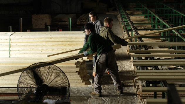 In this Friday, Dec. 21, 2012 photo, workers, from left, Aaron Roaf, Levi Wilson, and Jason Ray stack pieces of milled wood trim at Belco Forest Products in Shelton, Wash. The workers were hired after an audit by the U.S. Immigration and Customs Enforcement Department resulted in the layoff of more than 20 workers for having suspect documents authorizing them to work in the United States. (AP Photo/Ted S. Warren)