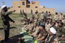 Shi'ite cleric Ahmed al-Rubaei speaks with Iraqi soldiers and Shiite fighters in Udhaim dam