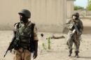 Nigerian soldiers patrol in the north of Borno state close to a Islamist extremist group Boko Haram former camp on June 5, 2013 near Maiduguri