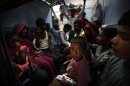 Passengers sit in a train and wait for power to get restored at a railway station in New Delhi, India, Monday, July 30, 2012. A major power outage has struck northern India, plunging cities into darkness and stranding hundreds of thousands of commuters. (AP Photo/Rajesh Kumar Singh)