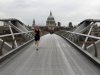 A man runs along an almost deserted Millennium Bridge, with St Paul's Cathedral in the background centre, in central London, Wednesday, Aug. 1, 2012. People are heeding government advice and staying away from central London during the London 2012 Olympics. (AP Photo/Sang Tan)