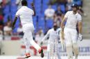 West Indies' Kemar Roach celebrates taking the wicket of England's captain Alistair Cook, right, during the opening day of their first cricket Test match at the Sir Vivian Richards Cricket Ground in Antigua, Antigua and Barbuda, Monday, April 13, 2015. (AP Photo/Ricardo Mazalan)