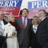 Republican presidential candidate, Texas Gov. Rick Perry leaves the State House in Concord, N.H., Friday, Oct. 28, 2011, with supporters after filing his papers to be on the ballot for the Nation's earliest presidential primary.  (AP Photo/Jim Cole)