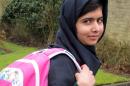 Malala Yousafzai holds a rucksack in Birmingham on March 19, 2013, as she returns to school for the first time since she was shot in the head by the Taliban