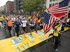 Runners who were unable to finish the Boston Marathon on April 15 because of the bombings cross the finish line on Boylston Street after the city allowed them to finish the last mile of the race in Boston, Saturday, May 25, 2013. (AP Photo/Winslow Townson)