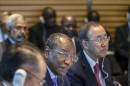 Guinean President Alpha Conde, center, flanked by World Bank President Jim Yong Kim, left, and United Nations Secretary General Ban Ki-moon, right, joins an international forum to discuss the Ebola outbreak and what help is needed by the West African nations that are stricken with the outbreak, at the World Bank in Washington, Thursday, Oct. 9, 2014. (AP Photo/J. Scott Applewhite)