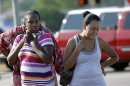 Parents, Eunice Pacheco, right, and LaKesia Brent, left, wait for news about their children outside Spring High School Wednesday, Sept. 4, 2013, in Spring, Texas. A 16-year-old boy has been airlifted from the school in suburban Houston with stab wounds suffered in an altercation at the campus. The Harris County Sheriff's Office says it responded about 7 a.m. Wednesday to Spring High School to a report of a stabbing. Spring is about 20 miles north of Houston. (AP Photo/David J. Phillip)