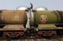 A worker walks atop a tanker wagon to check the freight level at an oil terminal on outskirts of Kolkata
