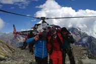 Rescuers assist a foreigner who was injured following an avalance at the Mount Manaslu base camp in Gorkha District, in this photograph released by Nepalese helicopter aviation service Simrik Air. The avalanche killed at least nine climbers trying to scale one of the world's most deadly peaks, according to officials