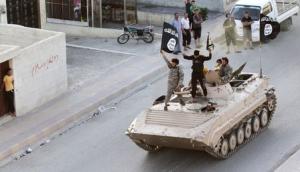Militant Islamist fighters take part in a military parade along the streets of northern Raqqa province