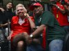 British entrepreneur Richard Branson, left, poses with AirAsia's Chief Executive Tony Fernandes while dressed up as an AirAsia flight attendant at a low cost carrier terminal in Malaysia, Sunday, May 12, 2013.  Branson wore the costume after losing a bet with his friend Fernandes on which of their 2010 Formula One racing car teams would finish ahead of the other. (AP Photo/Vincent Thian)