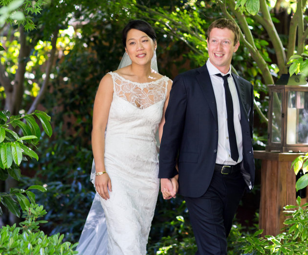 This photo provided by Facebook shows Facebook founder and CEO Mark Zuckerberg and Priscilla Chan at their wedding ceremony in Palo Alto, Calif., Saturday, May 19, 2012. Zuckerberg updated his status 