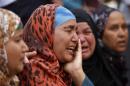 Relatives and families of Muslim Brotherhood members and supporters of ousted President Mursi react in front of the court in Minya