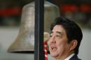 Japanese Prime Minister Shinzo Abe poses for photographers after sounding a bell during a ceremony marking the last session of the year 2013 at the Tokyo Stock Exchange in Tokyo Monday, Dec. 30, 2013 as Japan's Nikkei 225 index ended 2013 at its highest level in over six years. China's Foreign Ministry on Monday accused Abe of hypocrisy and said he would not be welcome in China after he visited a shrine honoring Japan's war dead. Ministry spokesman Qin Gang said that Abe's visit to the Yasukuni shrine in central Tokyo had seriously hurt relations between the countries and shut the door for dialogue between their leaders. (AP Photo/Shizuo Kambayashi)