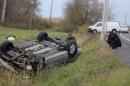 Surete du Quebec officer investigates an overturned vehicle in Saint-Jean-sur-Richelieu