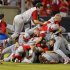 North Carolina State's Carlos Rodon (16) jumps on top of teammates as they celebrate their 5-4 win over Rice in the 17th inning of an NCAA college baseball tournament super regional game, Sunday, June 9, 2013, in Raleigh, N.C. (AP Photo/Karl B DeBlaker)