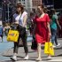 Women carry shopping bags through Times Square in New York