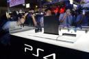 Visitors look at a display case containing Sony Computer Entertainment's PlayStation 4 at the Tokyo Game Show in Chiba, suburban Tokyo on September 19, 2013