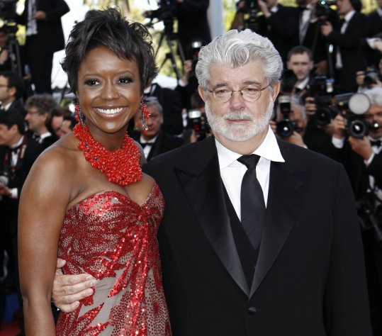 In this May 14, 2010 photo, Filmmaker George Lucas, right, and Mellody Hobson arrive for the screening of "Wall Street Money Never Sleeps", at the 63rd international film festival, in Cannes, southern France. A spokeswoman for Lucasfilm said on Thursday, Jan. 3, 2013, the 68-year-old director is engaged to 43-year-old investment firm president Mellody Hobson. (AP Photo/Matt Sayles, File)