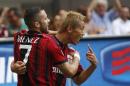 AC Milan forward Keisuke Honda, of Japan, right, celebrates with his teammate Jeremy Menez of France after scoring during a Serie A soccer match between AC Milan and Lazio, at the San Siro stadium in Milan, Italy, Sunday, Aug. 31, 2014. (AP Photo/Luca Bruno)