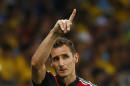 Germany's Klose gestures as he walks off the field after being substituted with teammate Schuerrle during their 2014 World Cup semi-finals against Brazil at the Mineirao stadium in Belo Horizonte