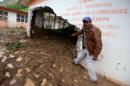 Resident shows a classroom damaged by a mudslide following heavy showers caused by the passing of Tropical Storm Earl, in the town of Temazolapa