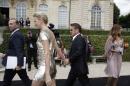 Actress Charlize Theron and actor Sean Penn arrive hand in hand at Dior's Fall-Winter 2014-2015 Haute Couture fashion collection, in Paris, France, Monday, July 7, 2014. (AP Photo/Thibault Camus)