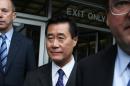 California State Senator Leland Yee (C) leaves the Phillip Burton Federal Building after a court appearance in San Francisco on March 31, 2014