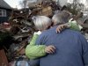 Sheila and Dominic Traina hug in front of their home which was demolished during Superstorm Sandy in Staten Island, N.Y., Friday, Nov. 2, 2012.  Mayor Michael Bloomberg has come under fire for pressing ahead with the New York City Marathon. Some New Yorkers say holding the 26.2-mile race would be insensitive and divert police and other important resources when many are still suffering from Superstorm Sandy. The course runs from the Verrazano-Narrows Bridge on hard-hit Staten Island to Central Park, sending runners through all five boroughs. The course will not be changed, since there was little damage along the route.  (AP Photo/Seth Wenig)