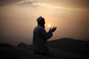 File photo of a Muslim pilgrim praying atop Mount Thor …