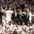 The Miami Heat players, coaches, owner and other staff pose with the Larry O'Brien Championship Trophy after their team defeated the San Antonio Spurs in Game 7 to win the NBA Finals basketball playoff in Miami