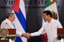 Mexican President Enrique Pena Nieto (R) and Cuban President Raul Castro shake hands during a joint press conference at the government palace in Merida, Yucatan State, Mexico, on November 6, 2015