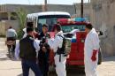 Members of the civil defence spray and clean areas in the town of Taza on March 13, 2016, that might have been contaminated in a chemical attack carried out by the Islamic State group