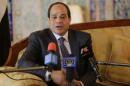 Egypt's President Abdel Fattah al-Sisi answers a question from the media upon his arrival at Algiers airport