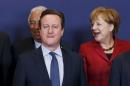 Britain's PM Cameron and Germany's Chancellor Merkel pose for a family photo during a EU leaders summit over migration in Brussels
