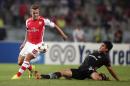 Besiktas's Necip Uysal, left, and Jack Wilshere of Arsenal fight for the ball during their Champions League play-off first leg soccer match in Istanbul, Turkey, Tuesday, Aug. 19, 2014. (AP Photo)