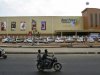 Two-wheelers move past the newly opened Bharti Wal-Mart Best Price Modern wholesale store in Hyderabad