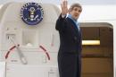 U.S. Secretary of State John Kerry waves as he boards his plane to return to the U.S., at Le Bourget Airport