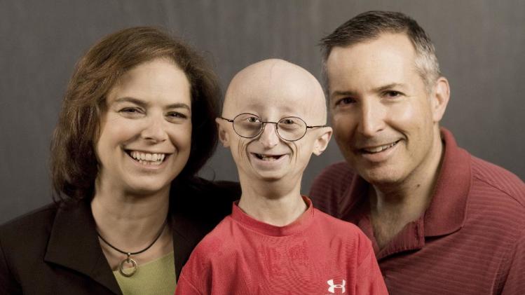 This undated photo provided by HBO shows Sam Berns, the subject of the HBO documentary, &quot;Life According to Sam,&quot; center, with his parents, Leslie Gordon, left, and Scott Berns. Sam Berns, 17, died Friday, Jan. 10, 2014 of complications from Hutchinson-Gilford progeria syndrome, commonly known as progeria. Hundreds of people, including New England Patriots owner Robert Kraft, attended his funeral on Tuesday, Jan. 14, 2014. (AP Photo/HBO, Sean Fine)