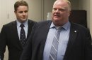 Toronto Mayor Ford walks with his staffer and policy advisor Johnston, moments before Johnston resigned from his position in Toronto